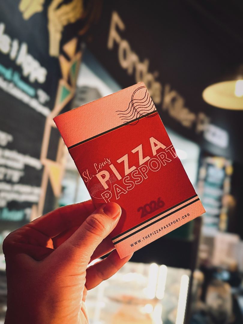 Holding pizza and passport