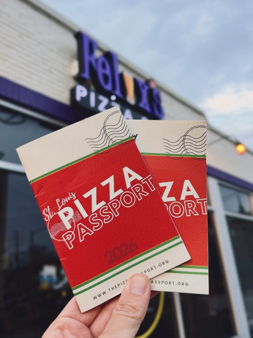 Holding up a pizza and the passport